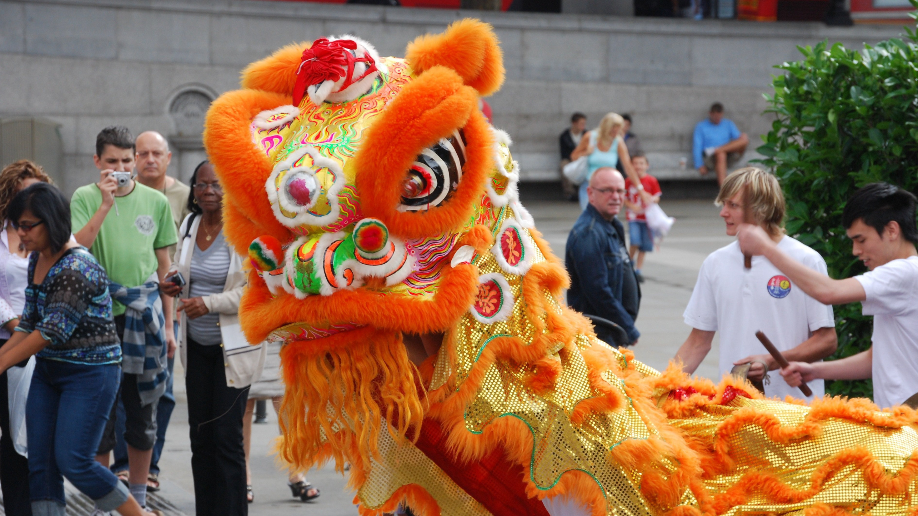 International tourists watching lion dance